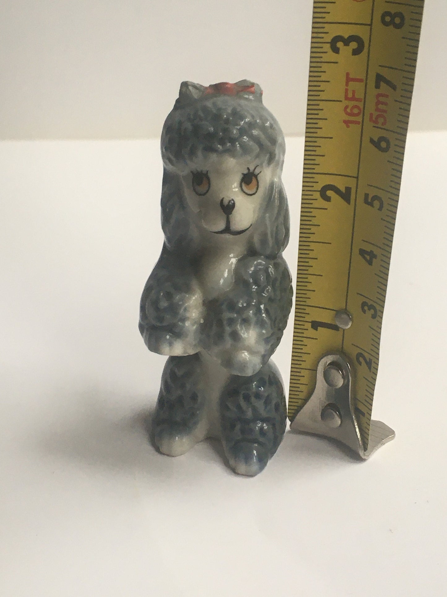 Wade Poodle. Vintage ceramic begging poodle with a red bow.
