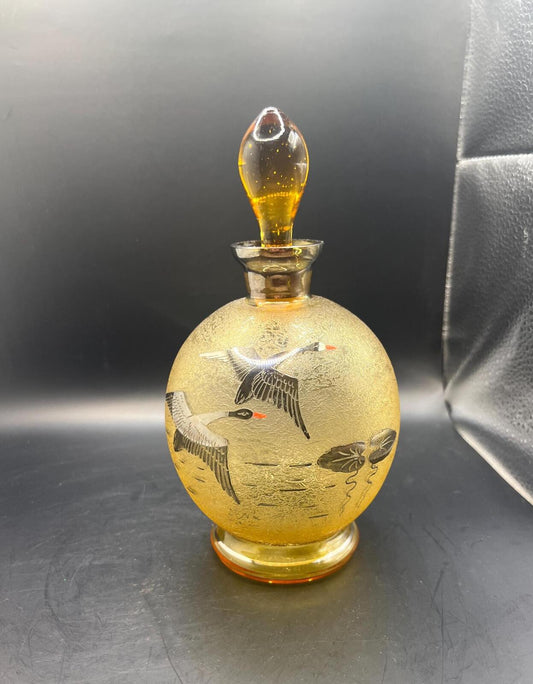 Vintage Bohemian amber glass decanter with a gold trim and a goose motif. Czechoslovakian MCM decor.