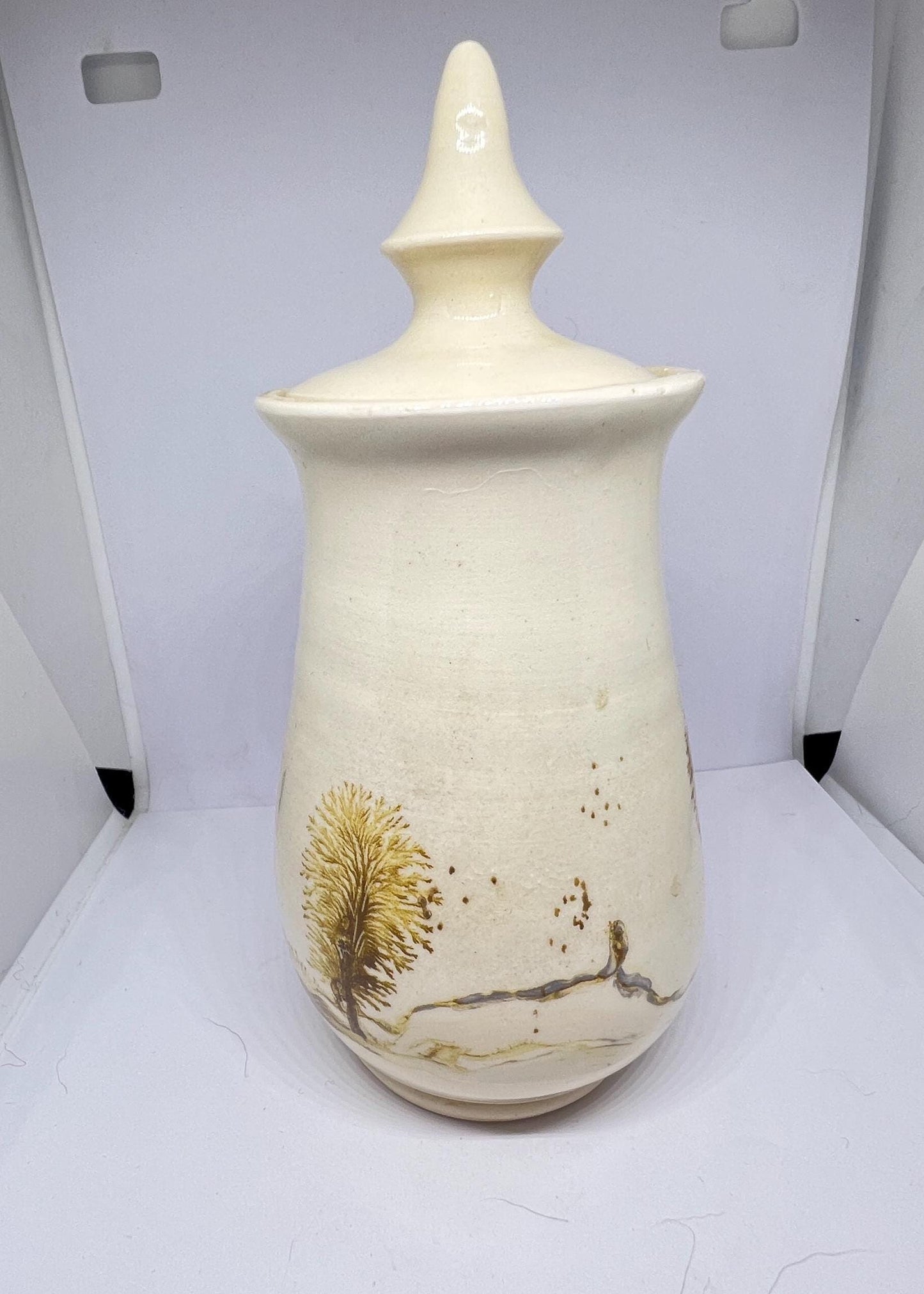 Studio pottery Mochaware lidded pot Cream glaze with tree design.