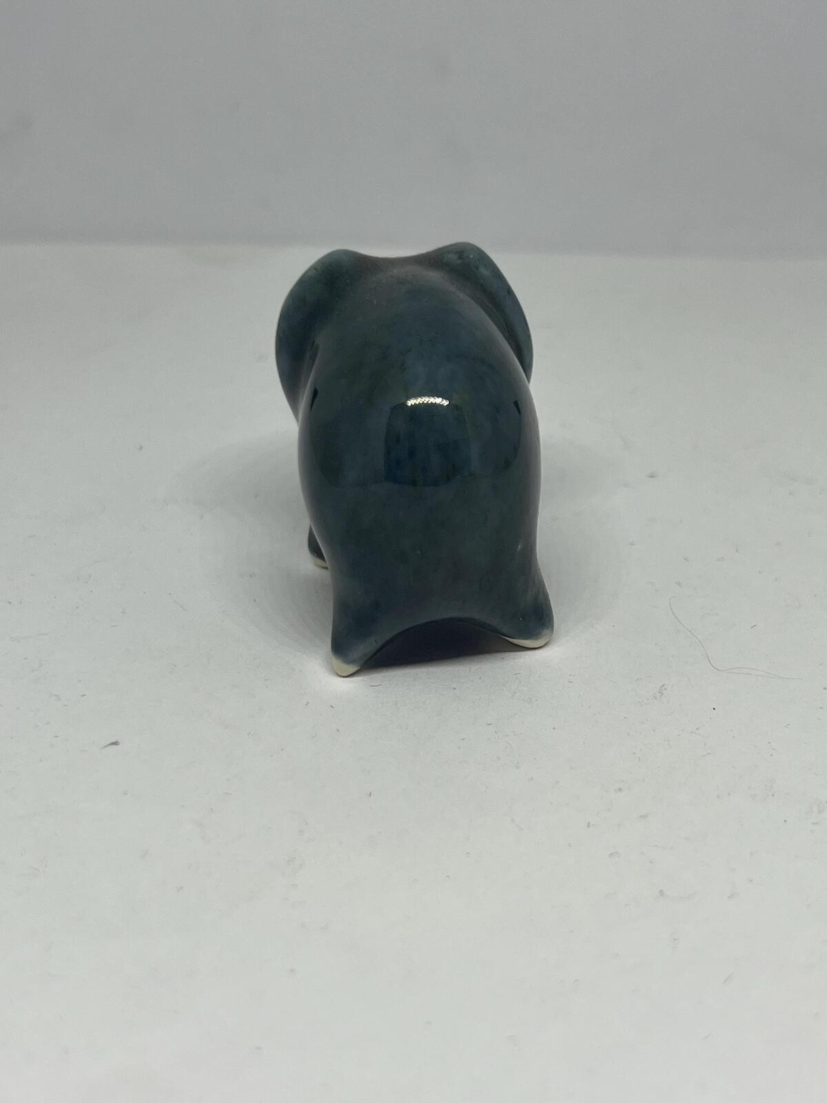 Tiny elephant figurine. Wellow pottery Blue green glaze stylised baby elephant.