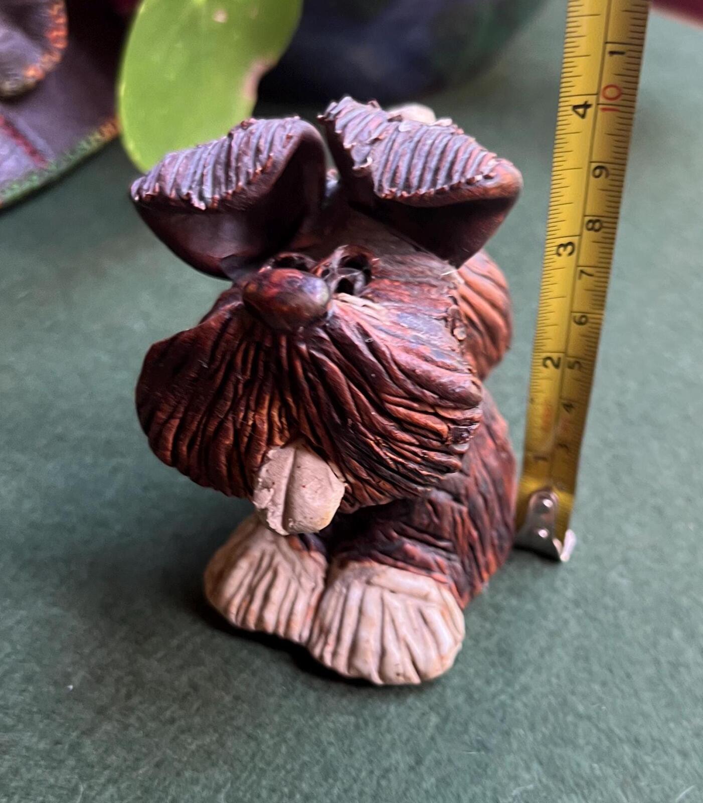 Hand built studio pottery brown glazed dog with its tongue out and quirky ears.