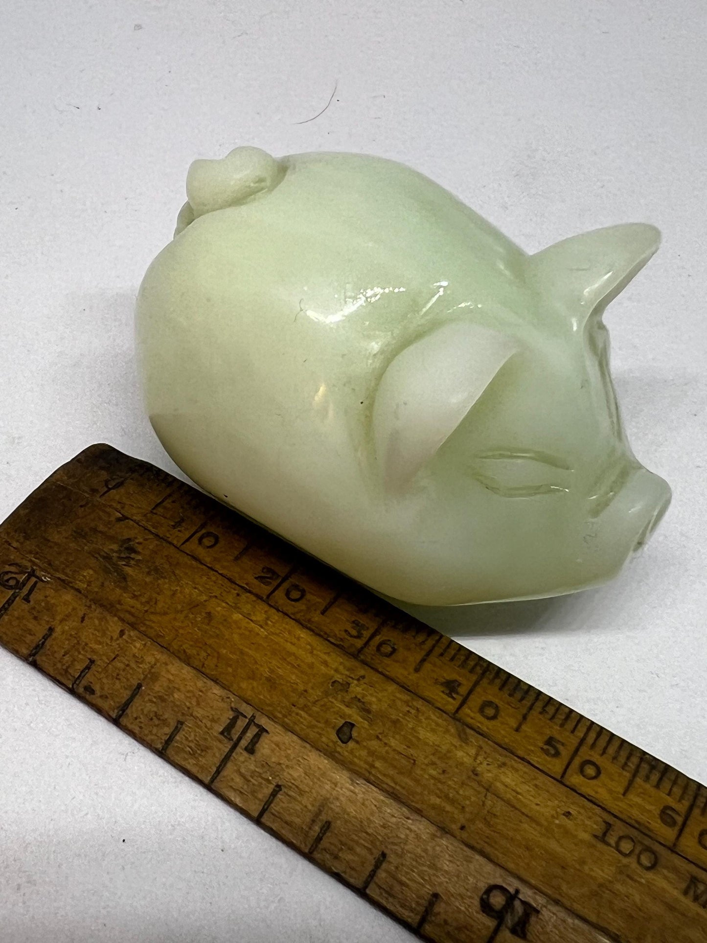 Vintage jade pig figurine. Cute carved white stone jade piglet ornament.