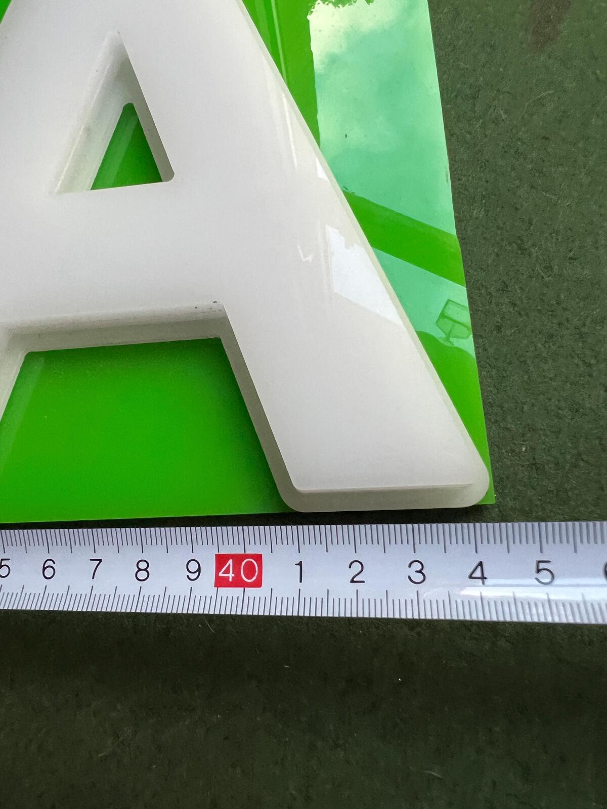 Vintage plastic TEA sign. White plastic letters on neon green background. Silver metal hanging chain.