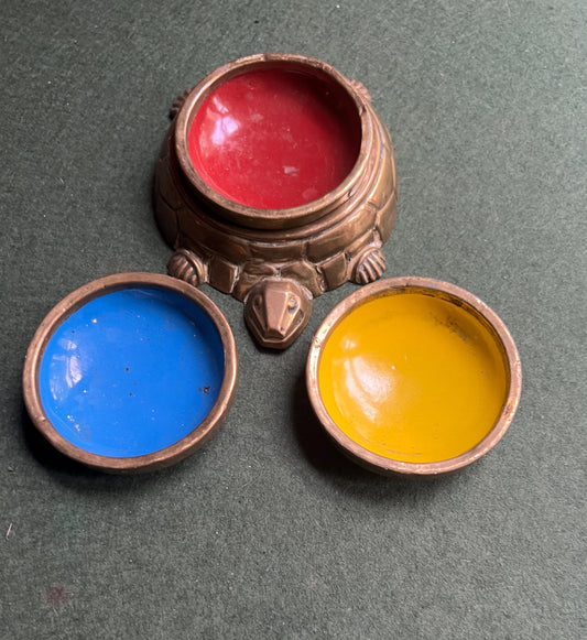 Quirky enamel brass stacking ashtrays on tortoise base.