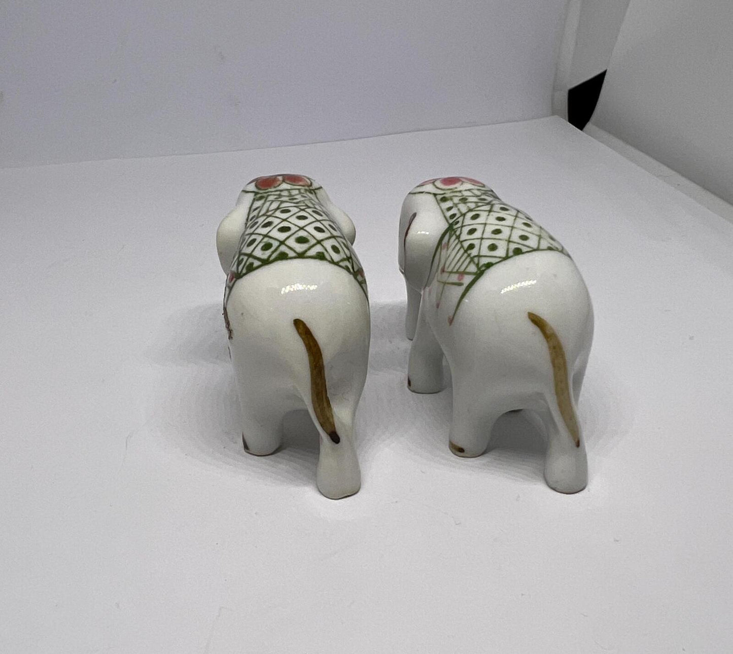 Tiny pair ceramic elephants. Mini ceremonial dress with floral headdress