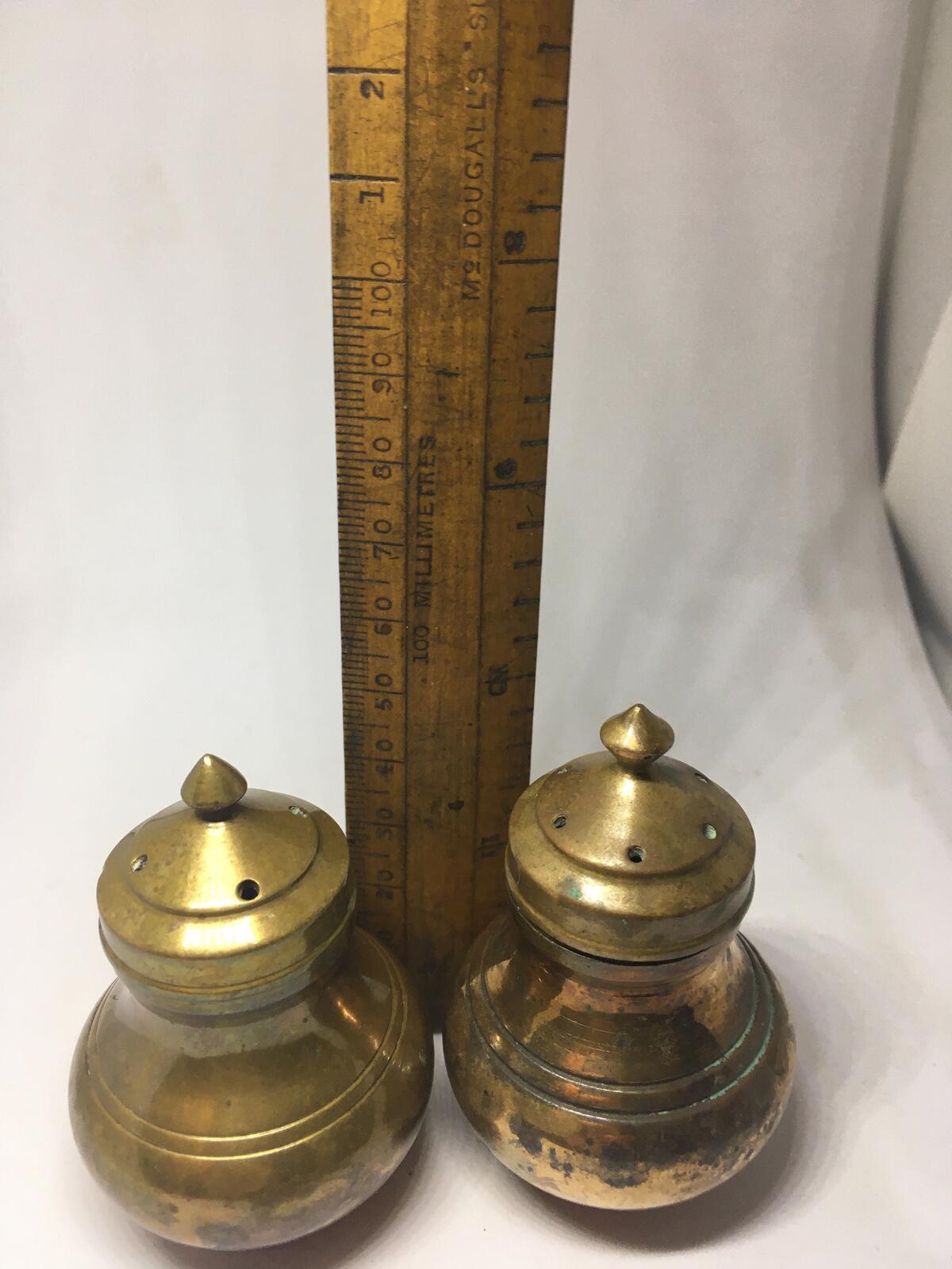 Unusual brass salt and pepper shakers. Screw off lids plastic inserts.