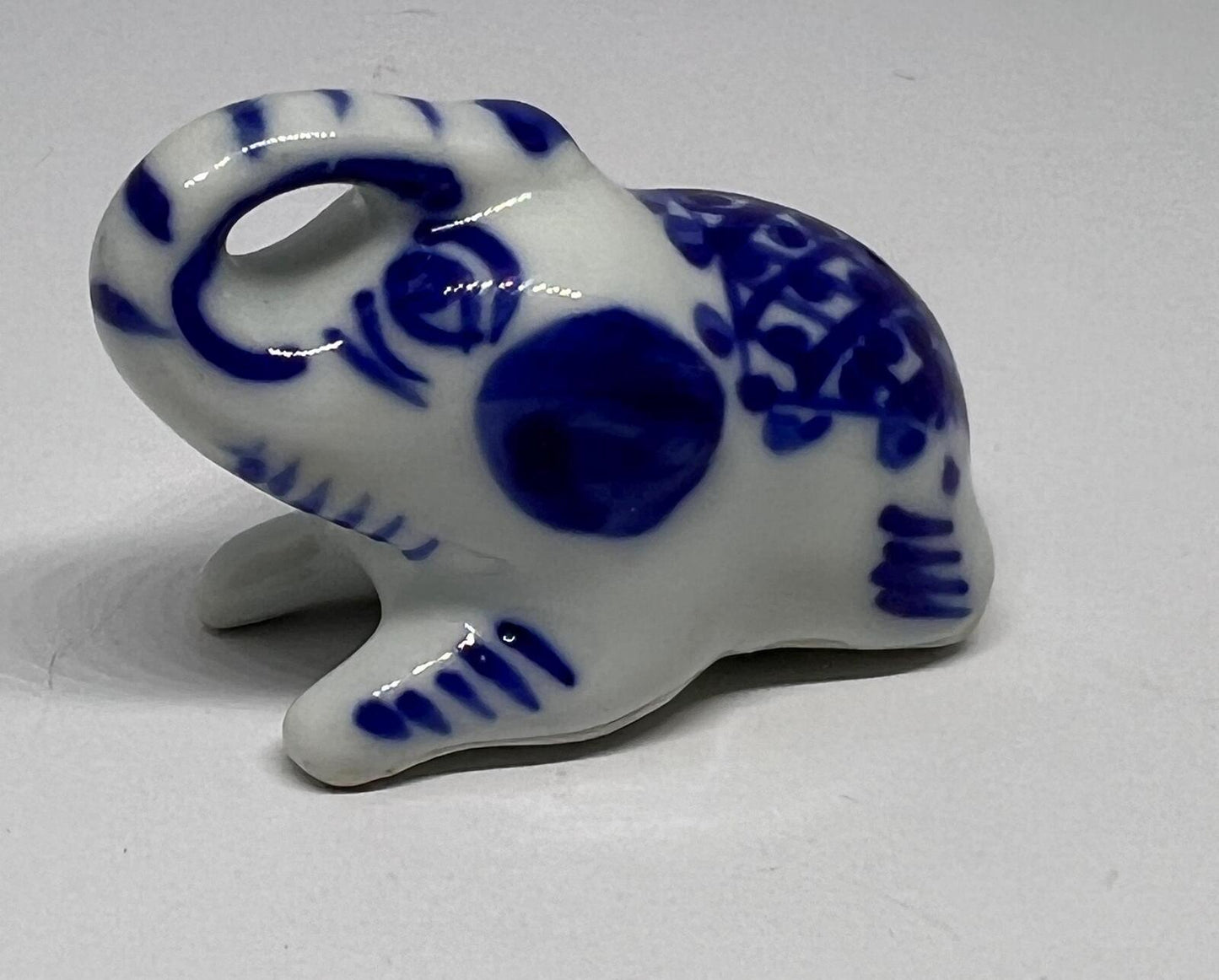 Lucky trunk up sitting elephant ornament. Blue white vintage elephant.