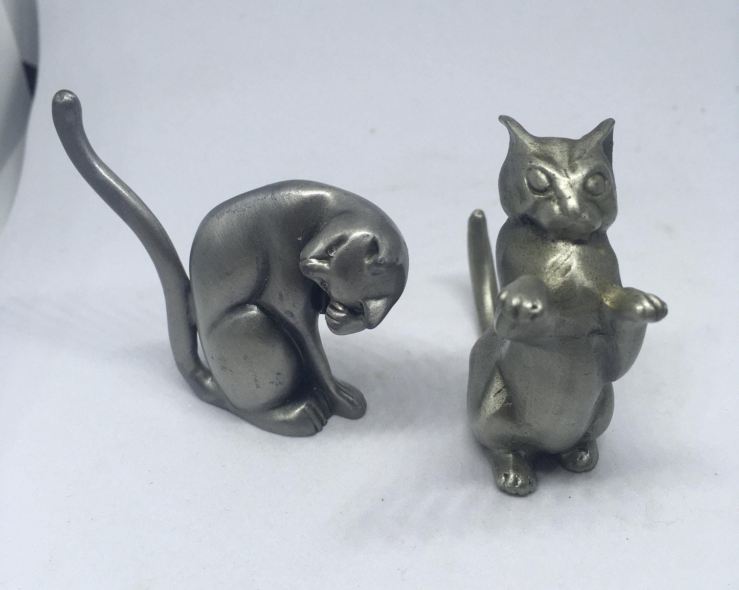 Two pewter cats.