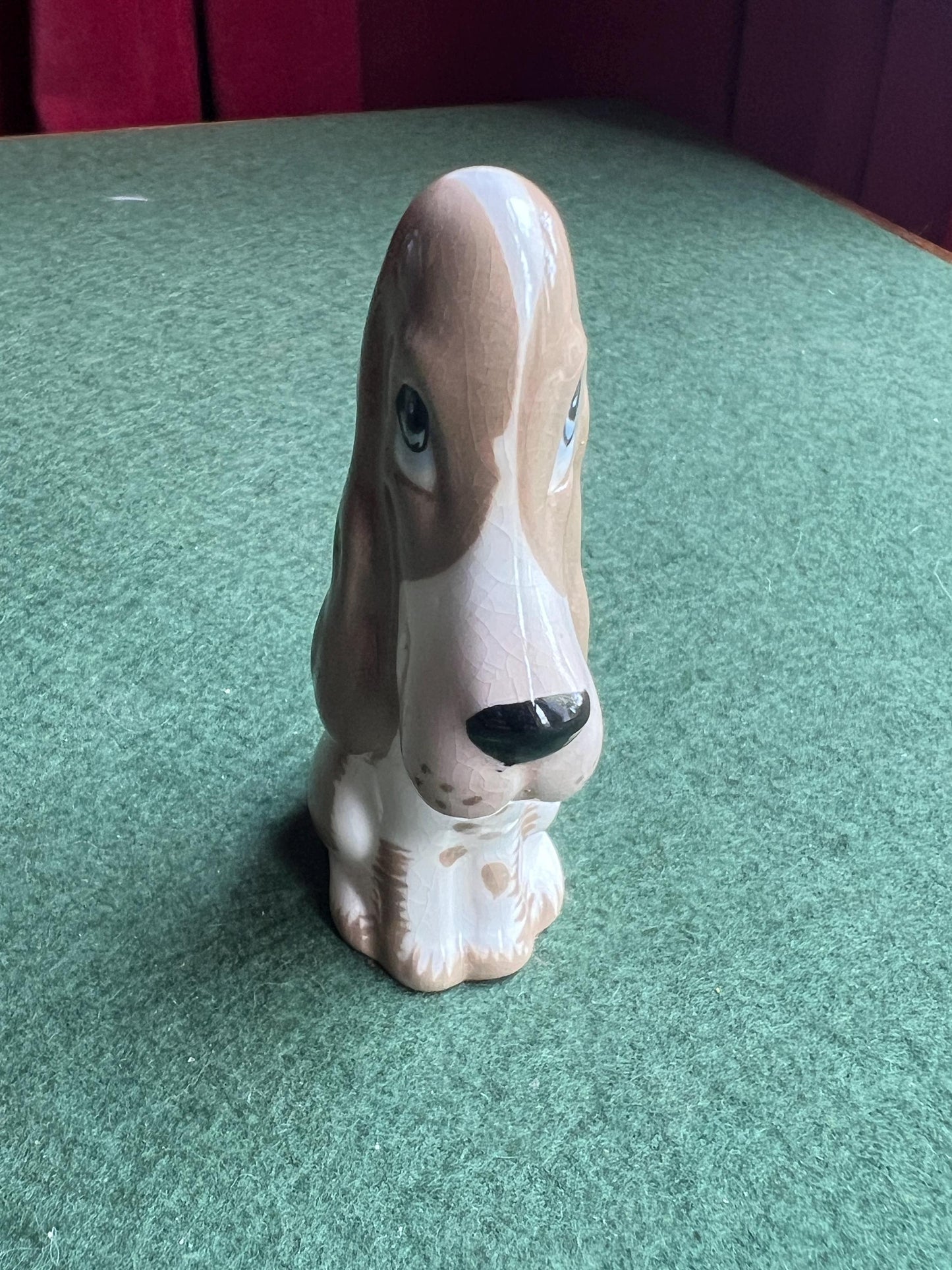 Ceramic sad hound dog figurine. Stamped Szeiler.