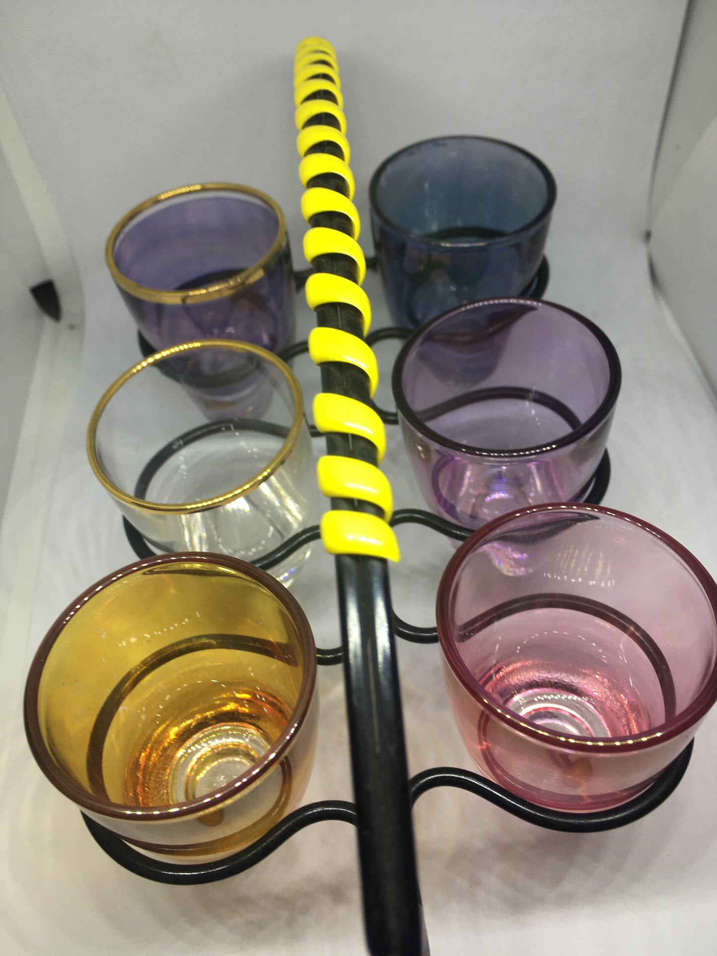 1950s Harlequin glass 6 shot glasses in wire holder.