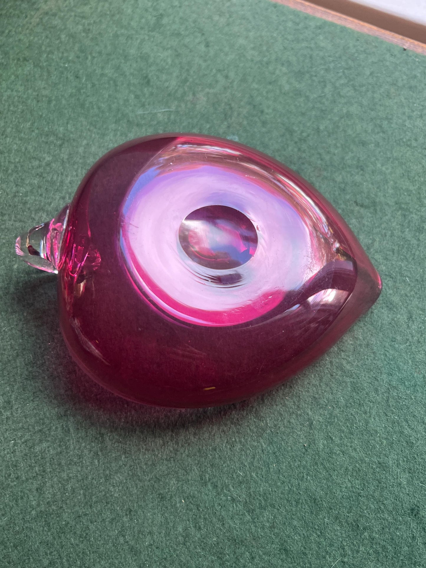 Hand blown cranberry glass heart shaped trinket dish. Applied clear handle.