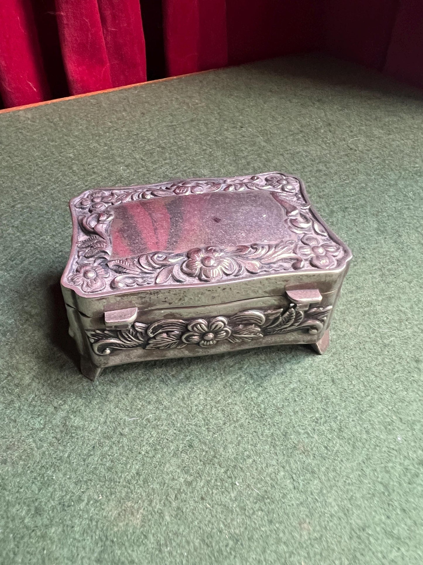 Vintage silver tone jewellery box. Embossed floral design treasure box blue lining.