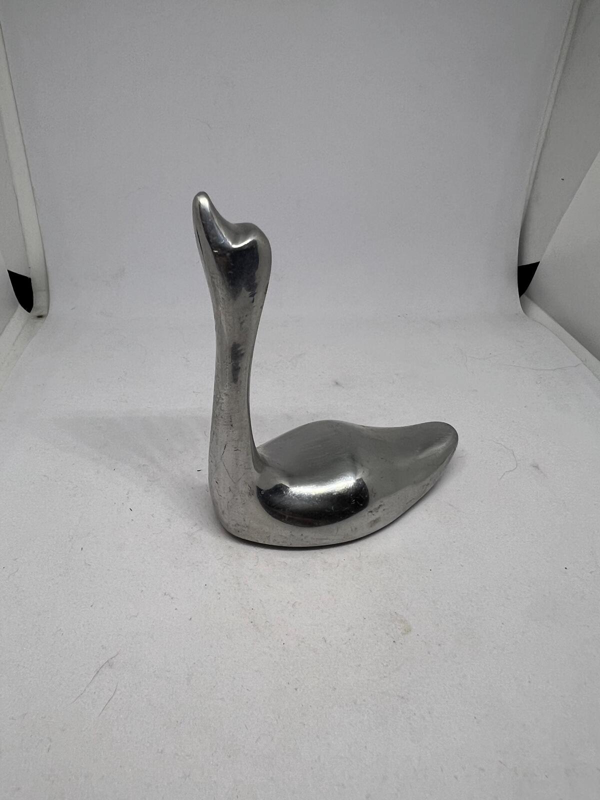 Silver tone swan figurine ring holder.  Signed to base Indistinct Canada 981.