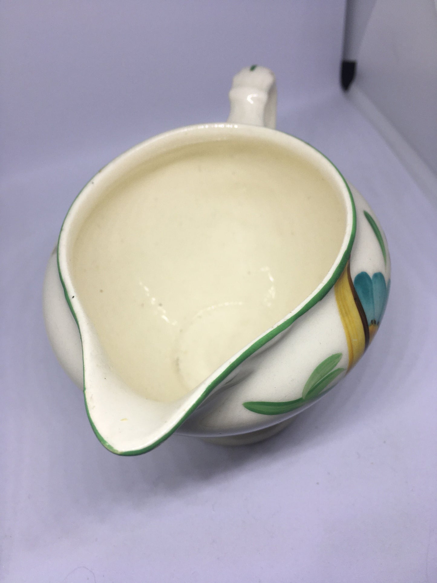 Ceramic hand painted milk jug. Stamped Ainsley England.