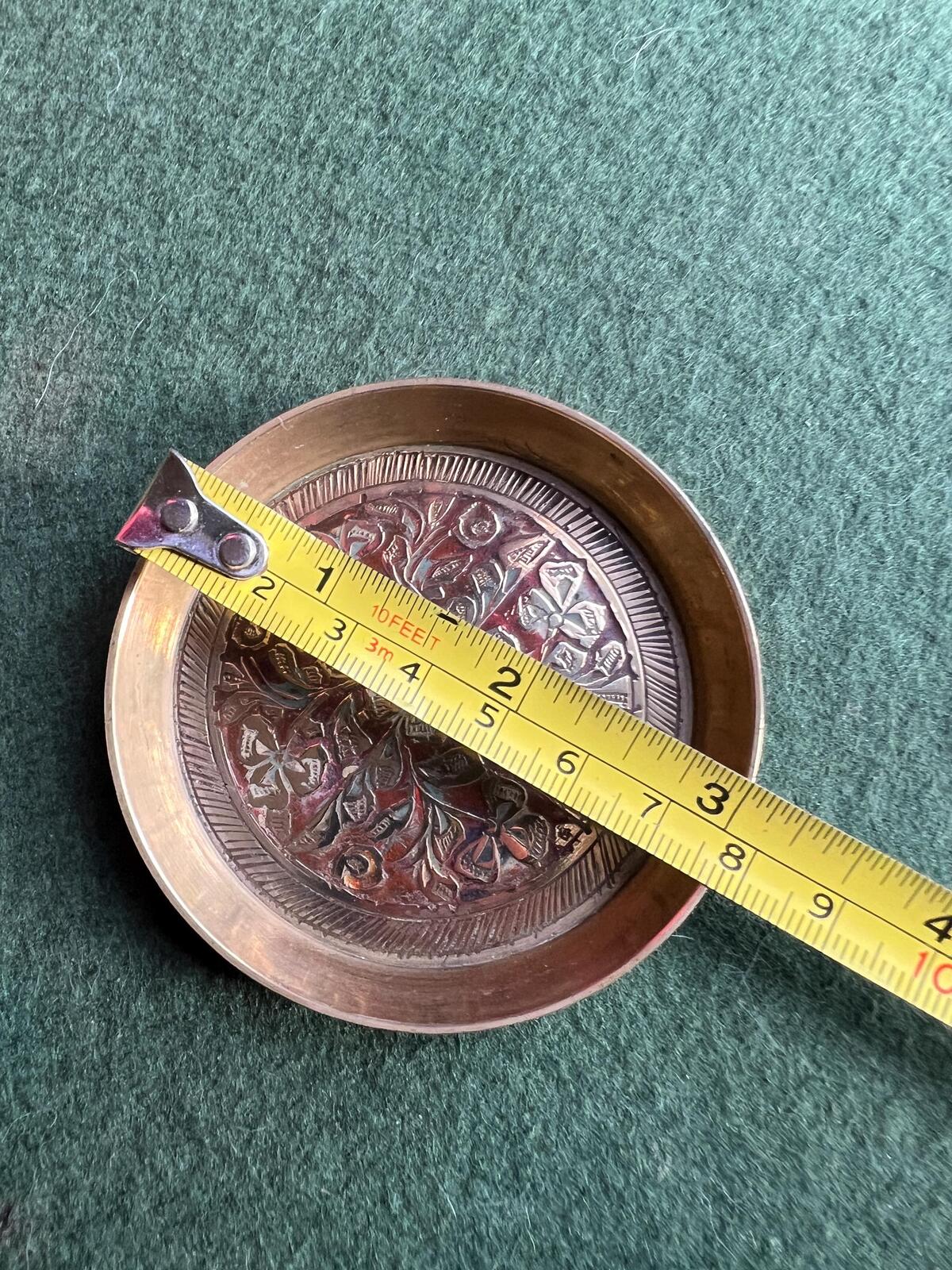 Decorative brass trinket tray. Engraved intricate red pattern. Made in India.