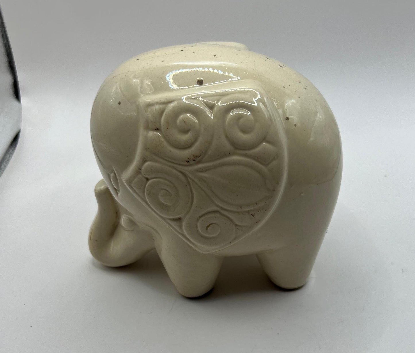 Quirky ceramic elephant figurine with decorated ears.