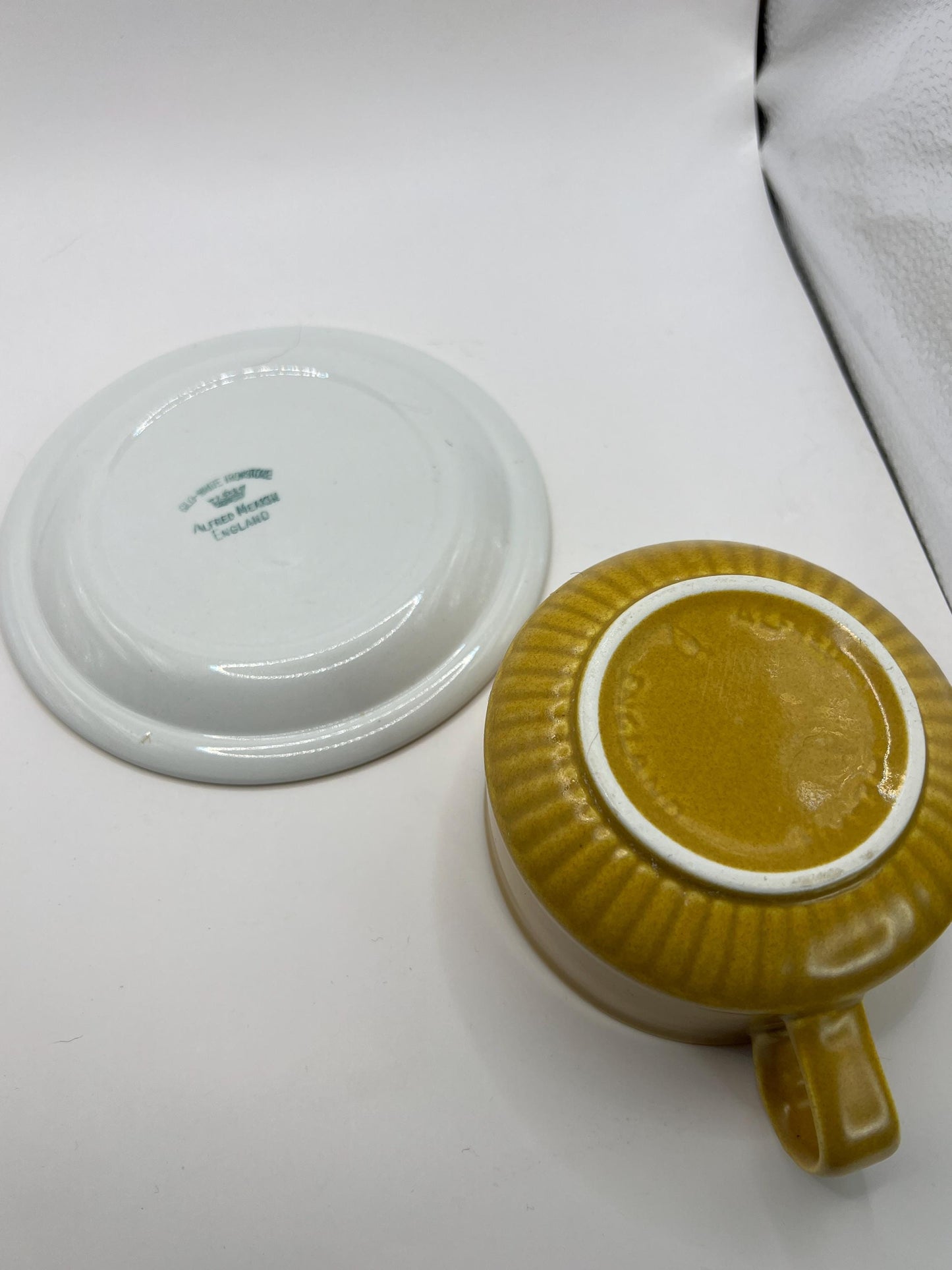 Mustard yellow ceramic gravy sauce boat and saucer. Stamped Glo-white Ironstone Alfred Meakin England.