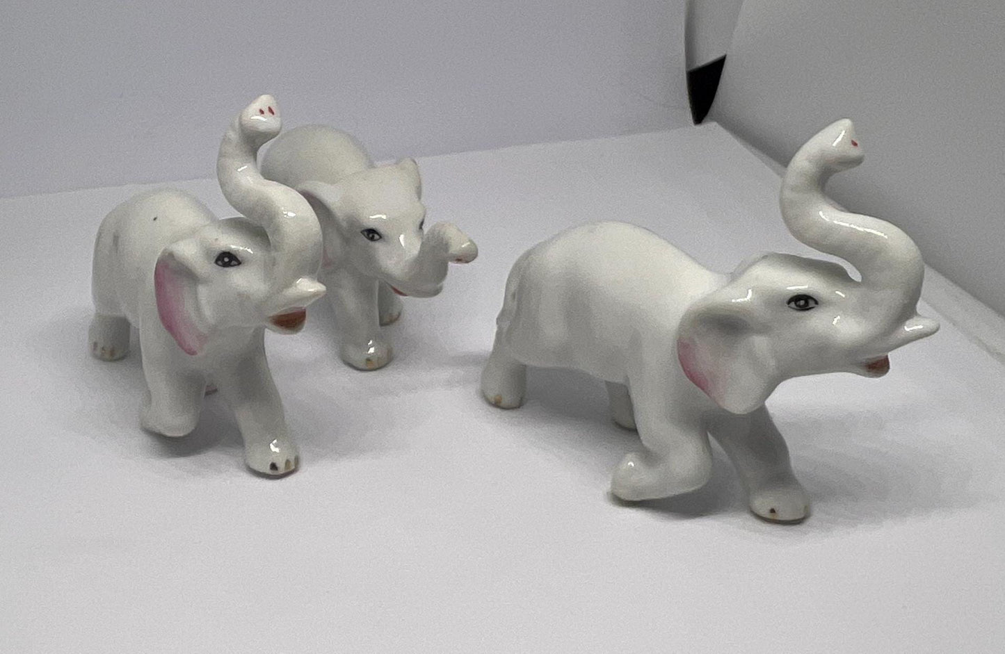 Ceramic elephant family. Lucky trunks raised mum dad and baby elephant collection.