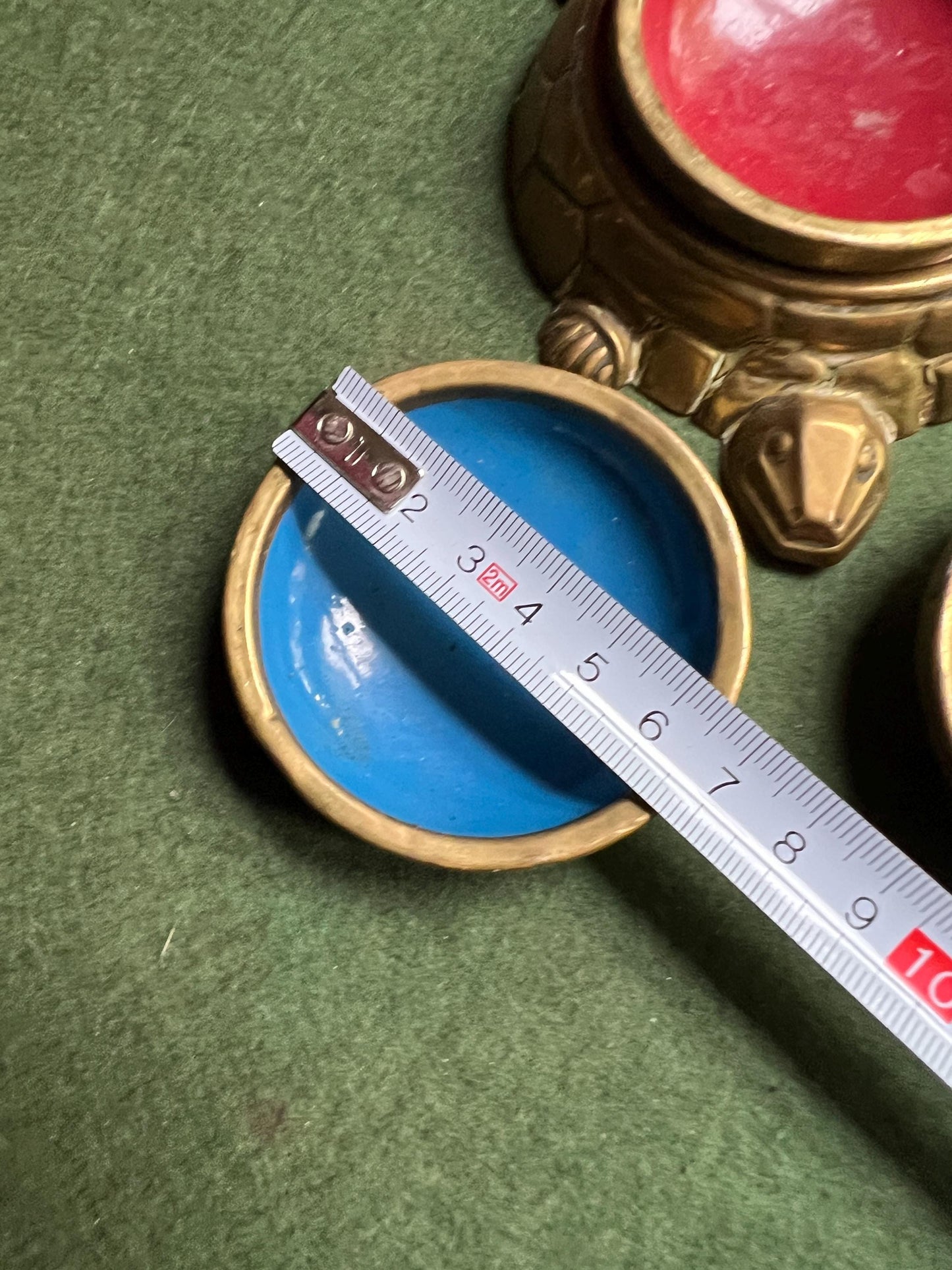 Quirky enamel brass stacking ashtrays on tortoise base.