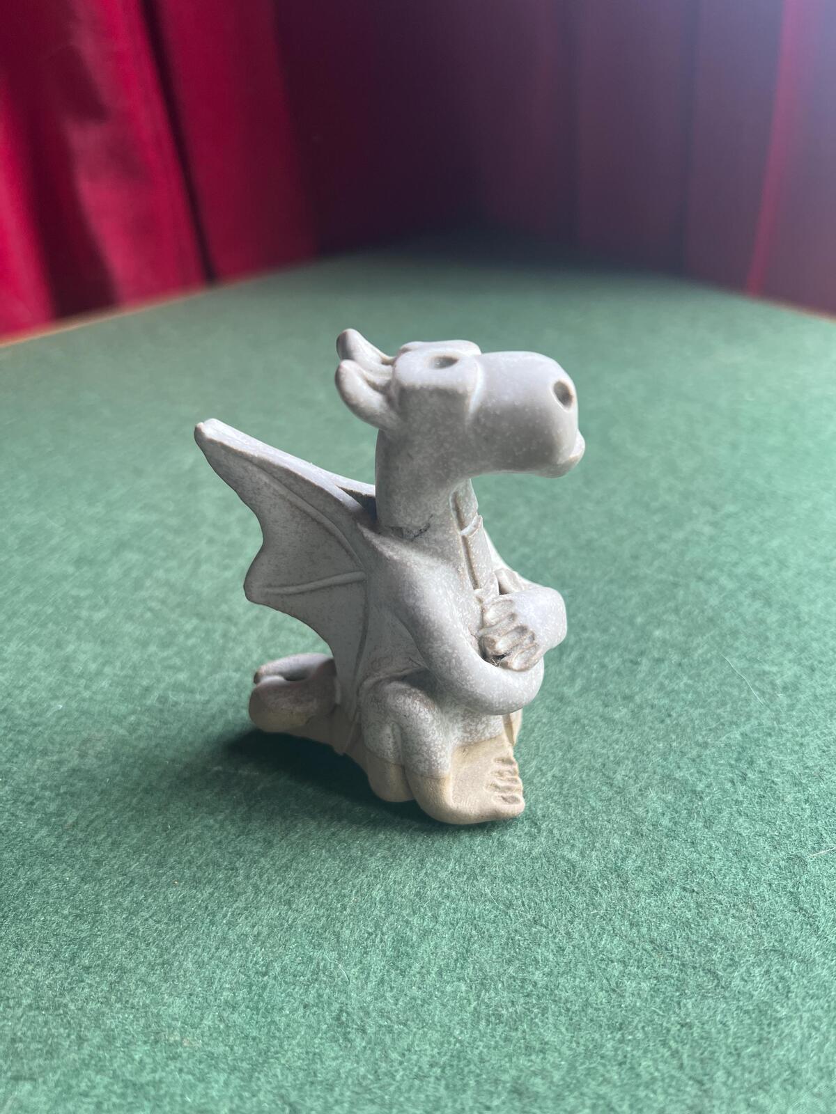 Hand built pottery dragon figurine. Grey clay ready to be painted dragon.